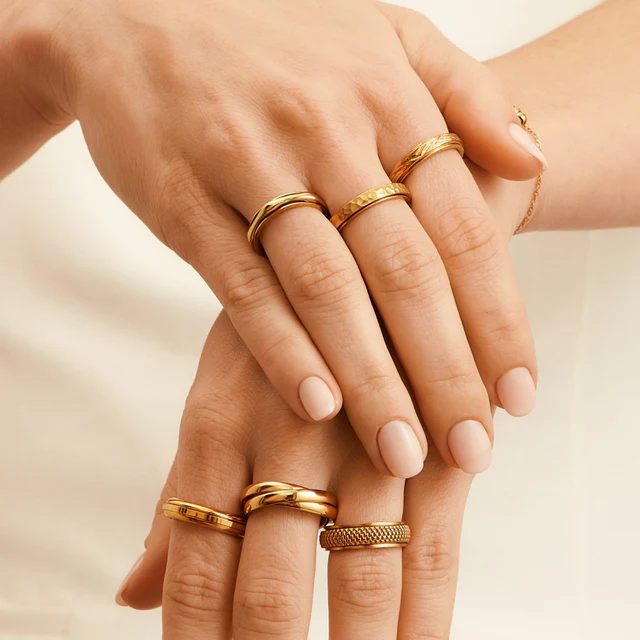 Woman's hand shows multiple rings on both hands